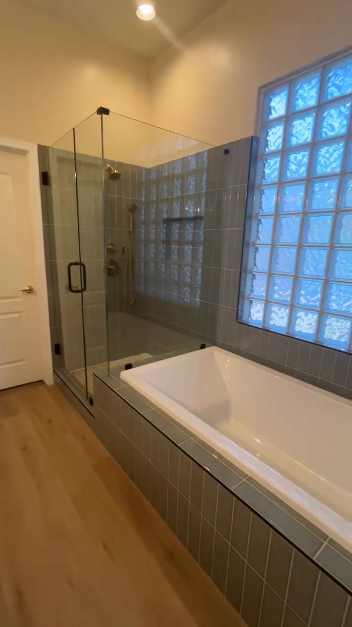 Glendale master bathroom remodel with polished sage green tile and brushed gold fixtures.